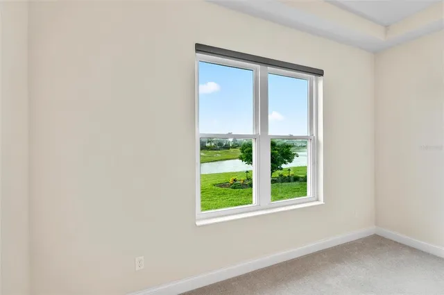 an aerial view of a house with a garden and lake view