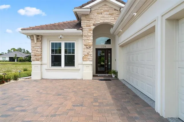 a view of a hallway with wooden floor and a bathroom