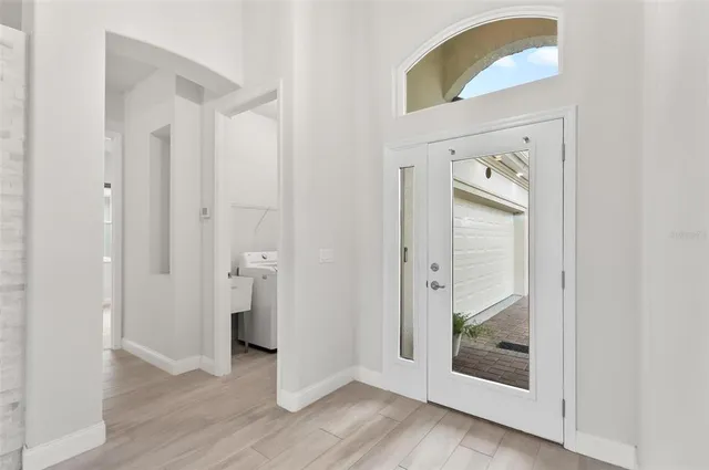 a view of empty room with wooden floor and fireplace