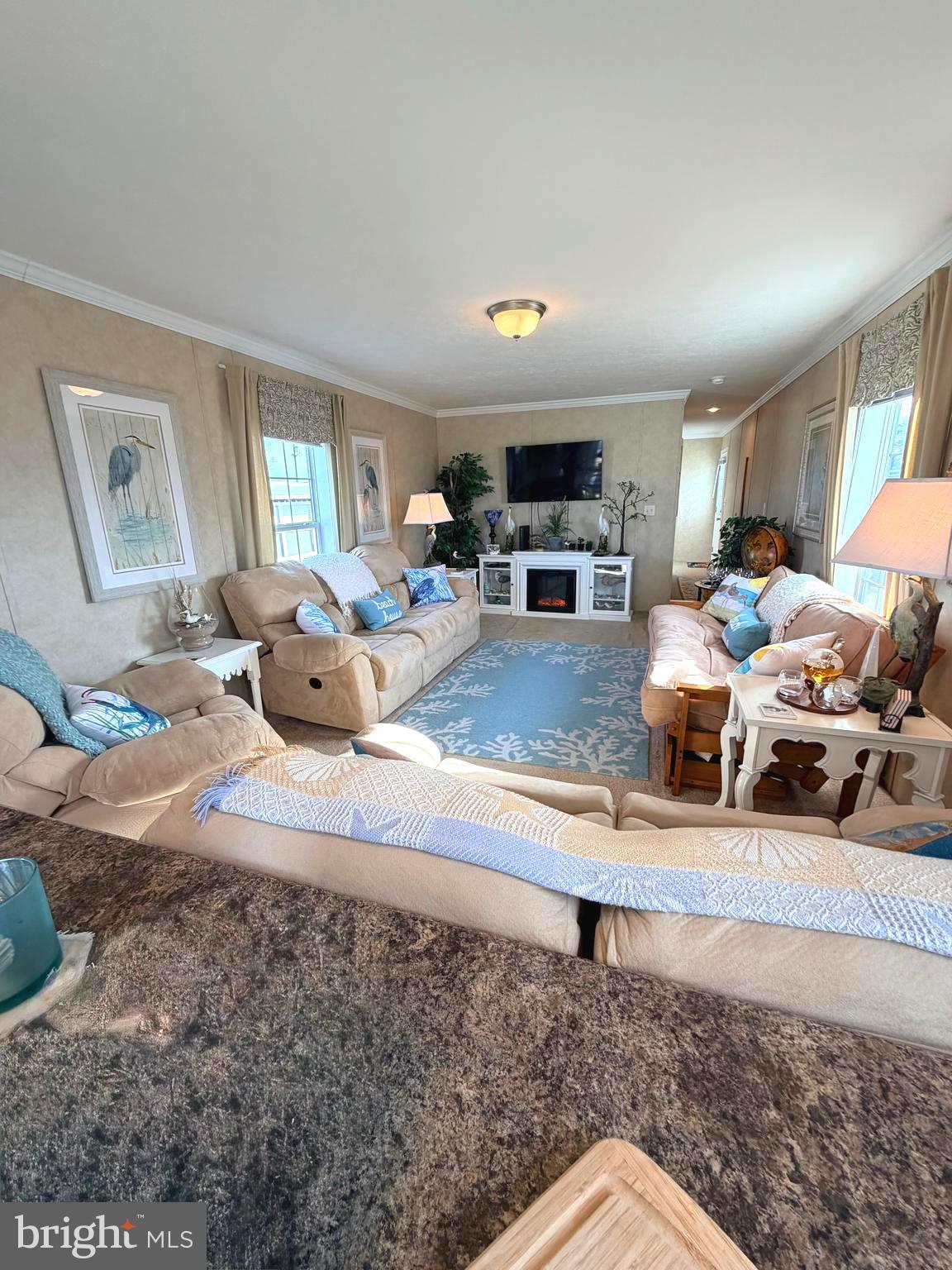 38025 Rabbit Road, Unit 101 Ocean View, DE 19970 - Photo 25 of 112 a living room with furniture and a flat screen tv