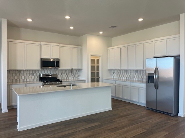 2711 Pine Bluff Drive Rosenberg, TX 77469 - Photo 3 of 12 a kitchen with stainless steel appliances granite countertop a stove a sink and a refrigerator