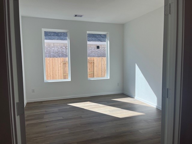 2711 Pine Bluff Drive Rosenberg, TX 77469 - Photo 4 of 12 an empty room with wooden floor and windows