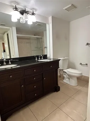 a view of a refrigerator in kitchen and livingroom