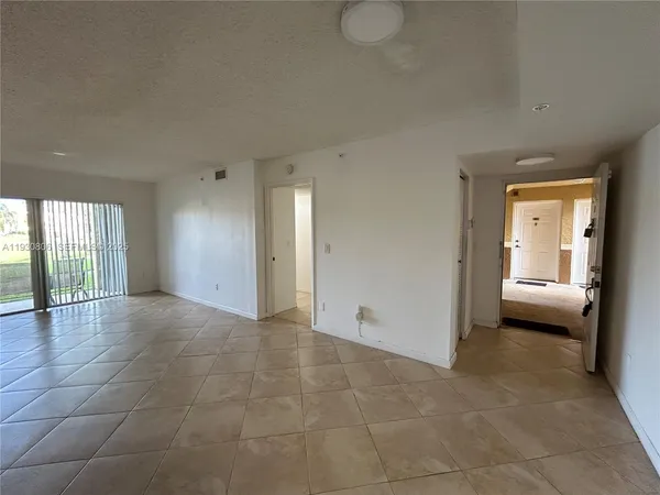 a view of a kitchen with a sink and a window