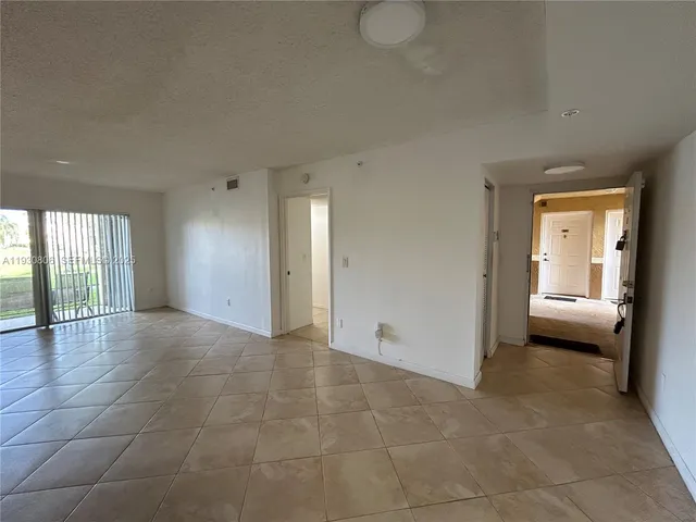 a view of a kitchen with a sink and a window