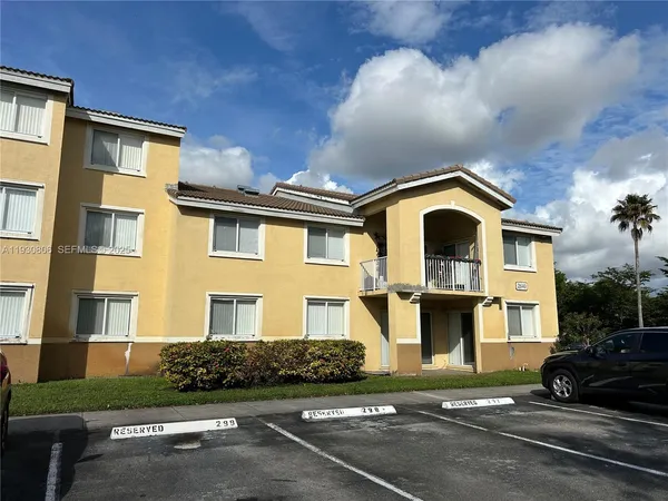 a front view of a residential apartment building with a yard