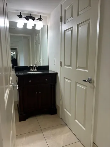 a bathroom with a sink a mirror and a shower