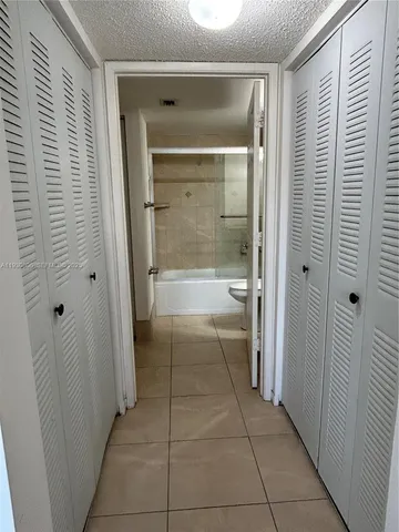 a bathroom with a shower and a sink
