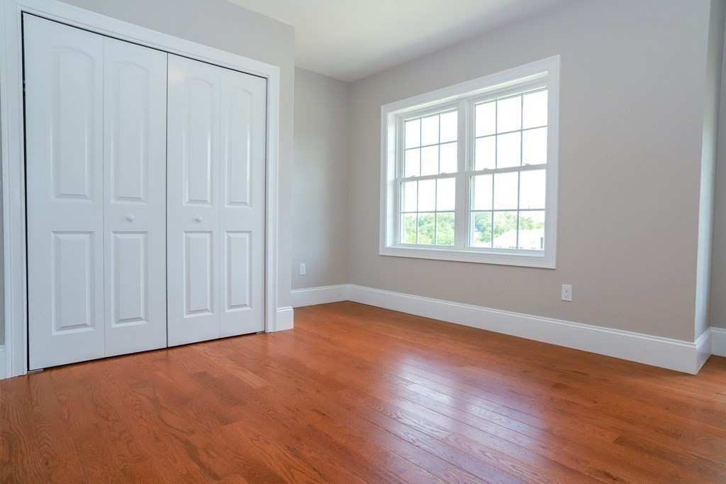 7 Ayer Road Littleton, MA 01460 - Photo 23 of 39 an empty room with wooden floor and windows