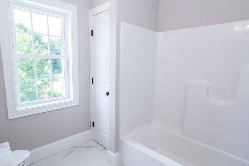 7 Ayer Road Littleton, MA 01460 - Photo 26 of 39 a white bath tub sitting next to a window