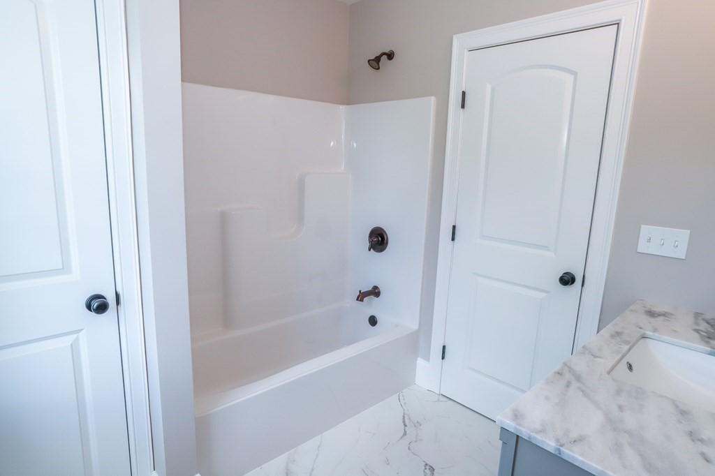7 Ayer Road Littleton, MA 01460 - Photo 27 of 39 a bathroom with a bathtub and a sink
