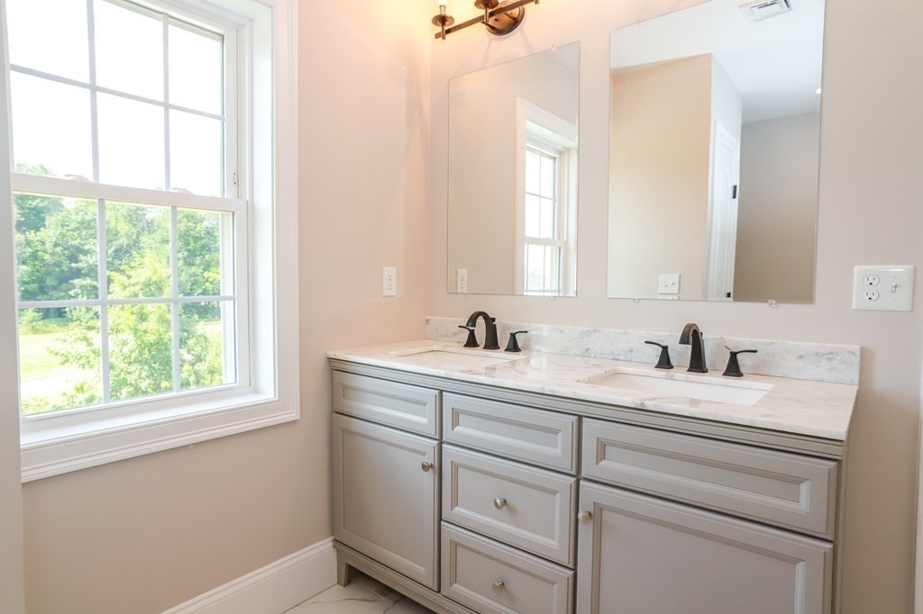 7 Ayer Road Littleton, MA 01460 - Photo 35 of 39 a bathroom with a sink and a window