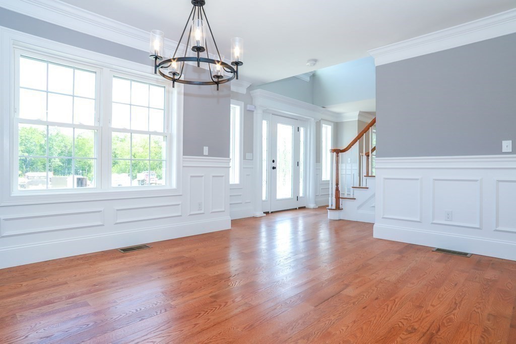 7 Ayer Road Littleton, MA 01460 - Photo 5 of 39 a view of empty room with wooden floor and fan