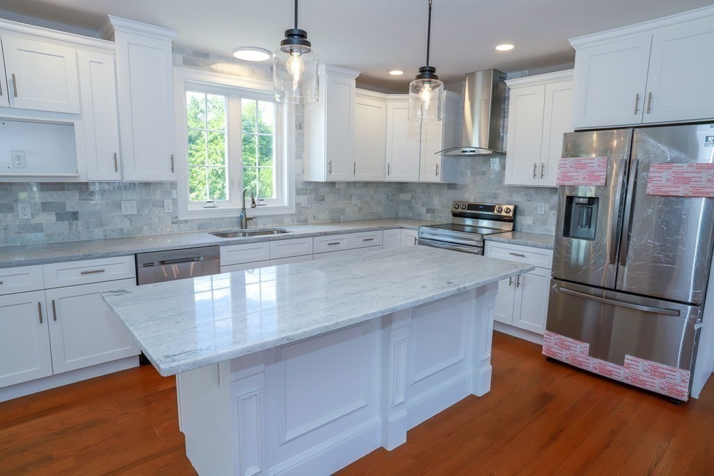 7 Ayer Road Littleton, MA 01460 - Photo 7 of 39 a kitchen with stainless steel appliances granite countertop a sink a stove and a refrigerator
