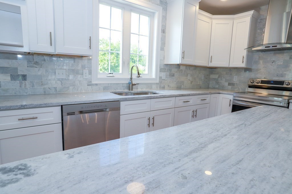 7 Ayer Road Littleton, MA 01460 - Photo 8 of 39 a kitchen with stainless steel appliances granite countertop a sink a stove and cabinets