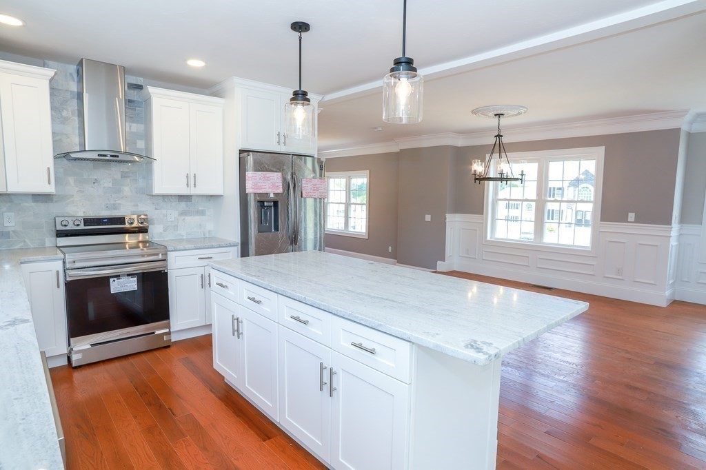7 Ayer Road Littleton, MA 01460 - Photo 10 of 39 a kitchen with stainless steel appliances granite countertop hardwood floor sink stove and wooden floor