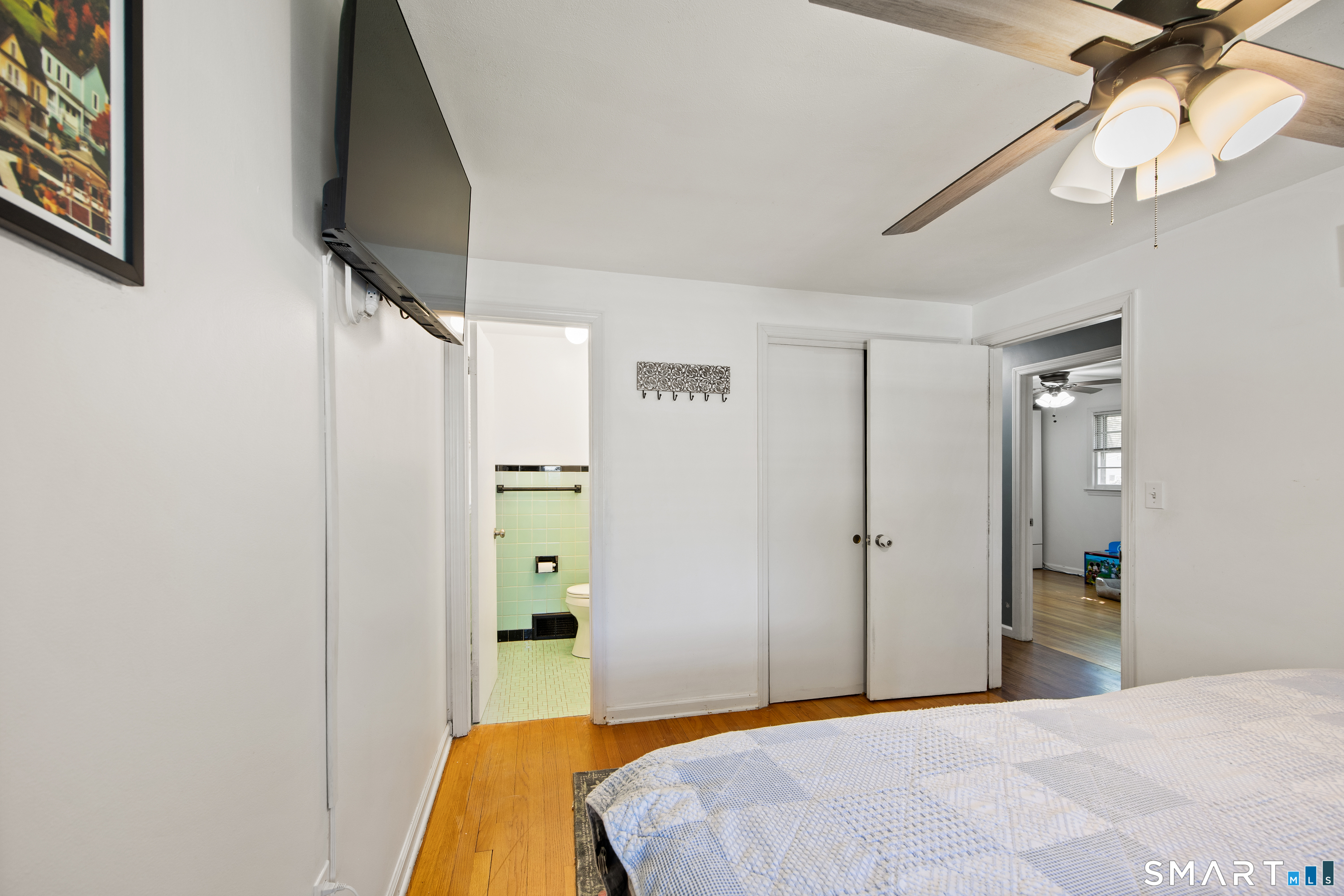 39 Grove Road North Haven, CT 06473 - Photo 25 of 38 a bedroom with a bed and a flat screen tv