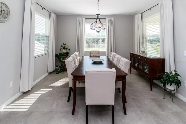 a dining room with furniture and window