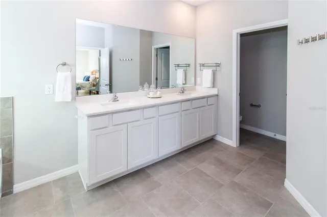 a bathroom with a double vanity sink and mirror