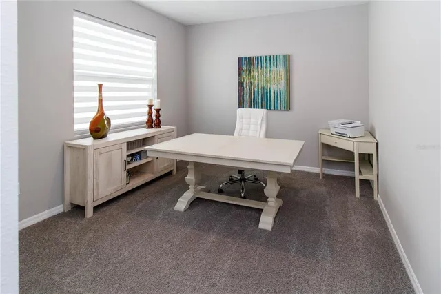 a room with table chairs and windows