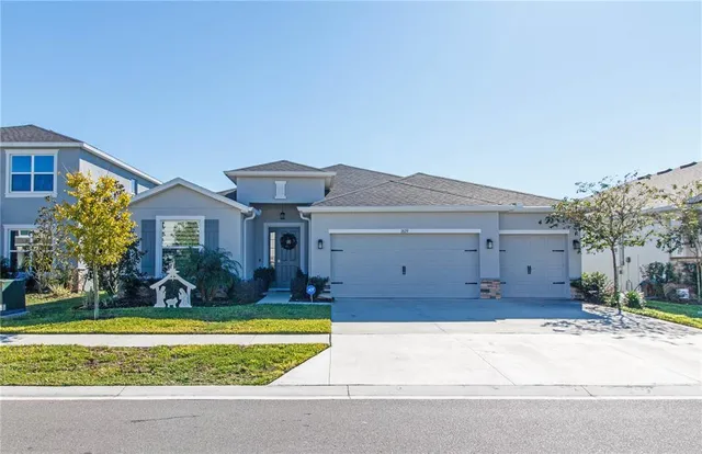 a front view of a house with a yard and garage