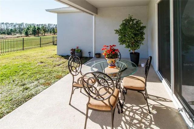 a view of outdoor dining space with a table and chairs