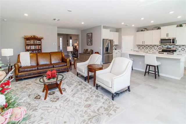 a living room with furniture and kitchen view
