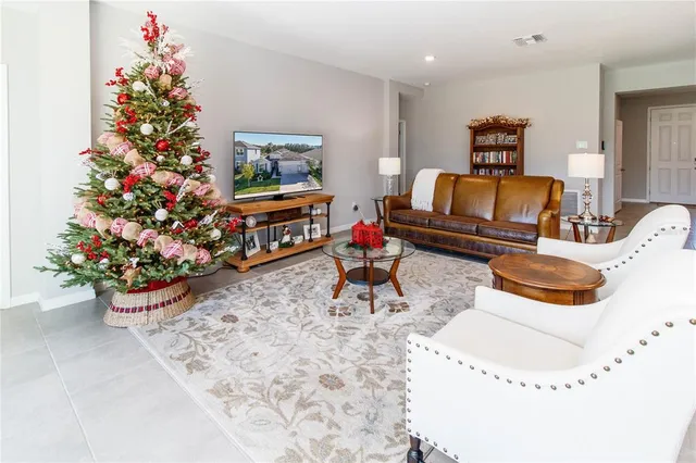 a living room with furniture and flowers
