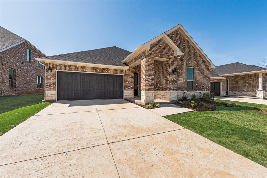 4136 Tarlton Road Little Elm, TX 75068 - Photo 4 of 28 a front view of a house with a yard and garage