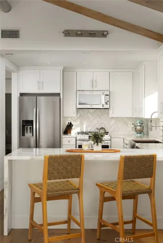 a kitchen with a dining table and chairs