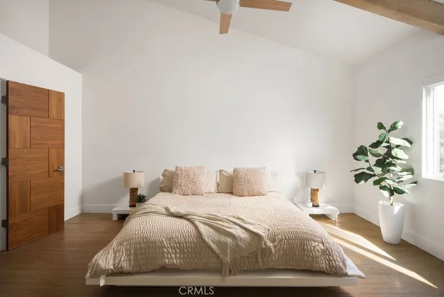 a bedroom with a bed and window