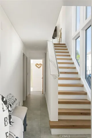 a view of entryway and hall with wooden floor