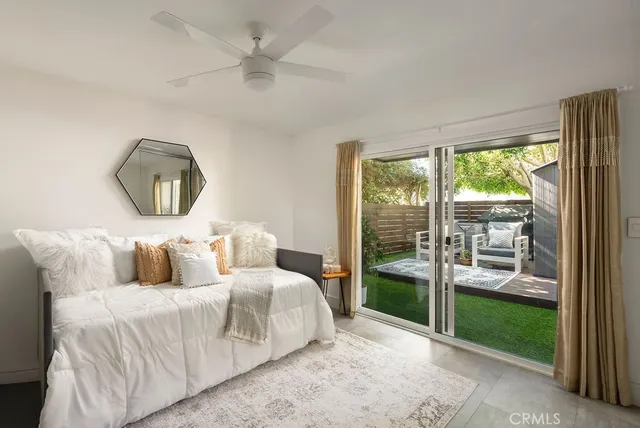 a bedroom with a bed mirror and window