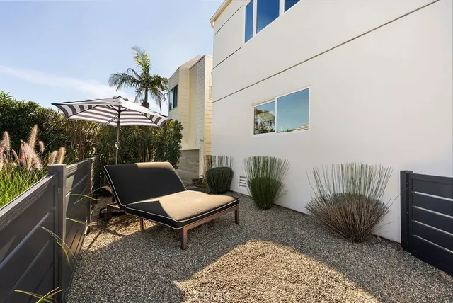 a view of a patio with a table and chairs