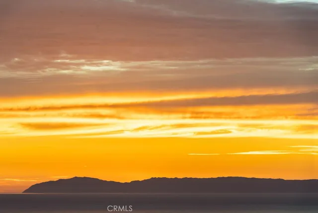 a view of an ocean with a mountain