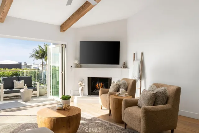 a living room with furniture a fireplace and a flat screen tv