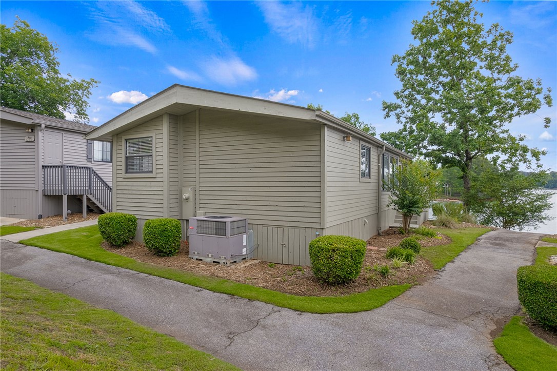 1230 Melton Road, Unit 30 West Union, SC 29696 - Photo 25 of 42 A lakeside retreat with a spacious yard and inviting pathways.