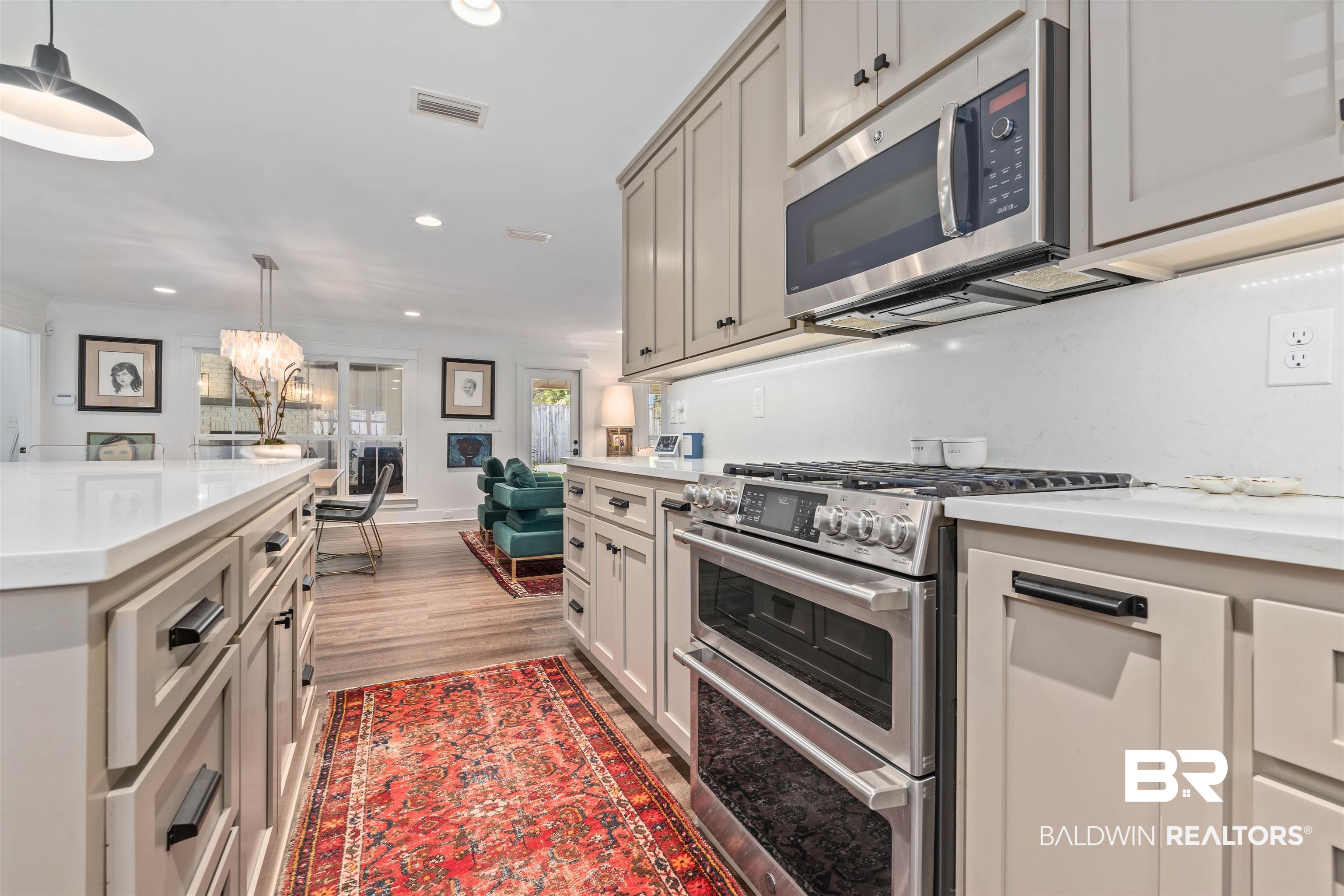 3808 Claridge Road North Mobile, AL 36608 - Photo 12 of 43 Kitchen featuring stainless steel appliances, gray cabinetry, pendant lighting, light hardwood / wood-style floors, and a chandelier
