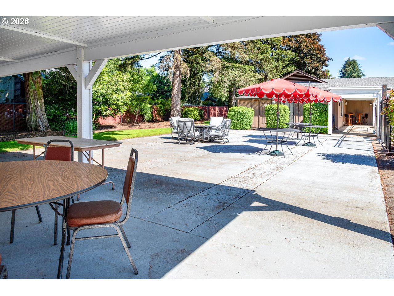 1475 Green Acres Road, Unit 172 Eugene, OR 97408 - Photo 27 of 35 a view of a patio with a table chairs and a backyard