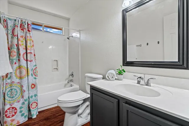 a view of a hallway with wooden floor and entryway