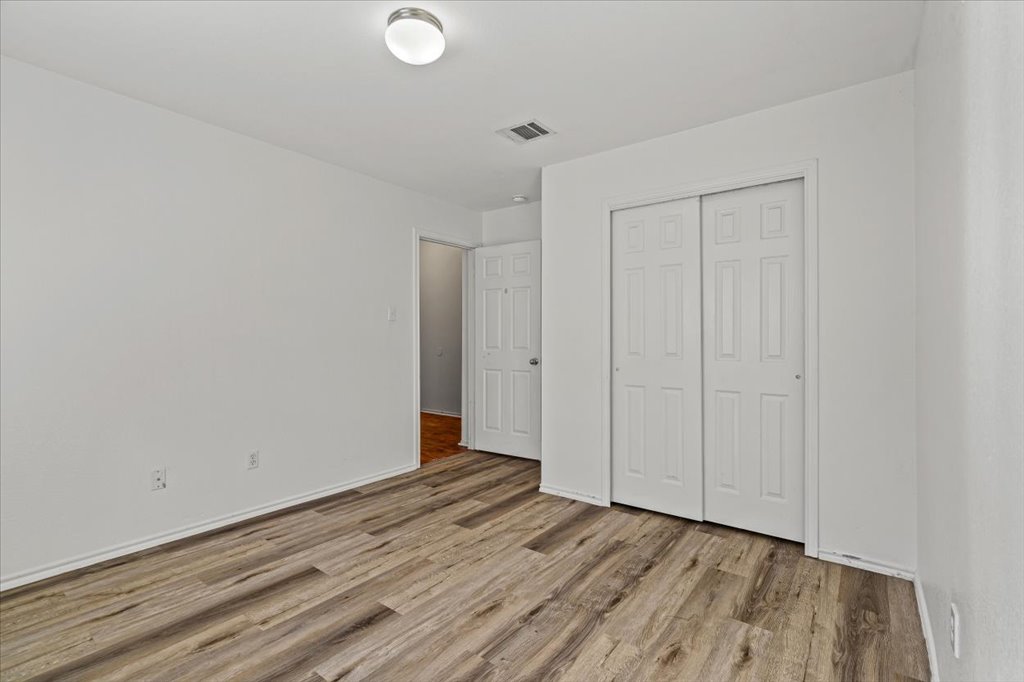 17912 Aleppo Pine Elgin, TX 78621 - Photo 22 of 30 Unfurnished bedroom featuring a closet and light wood-type flooring