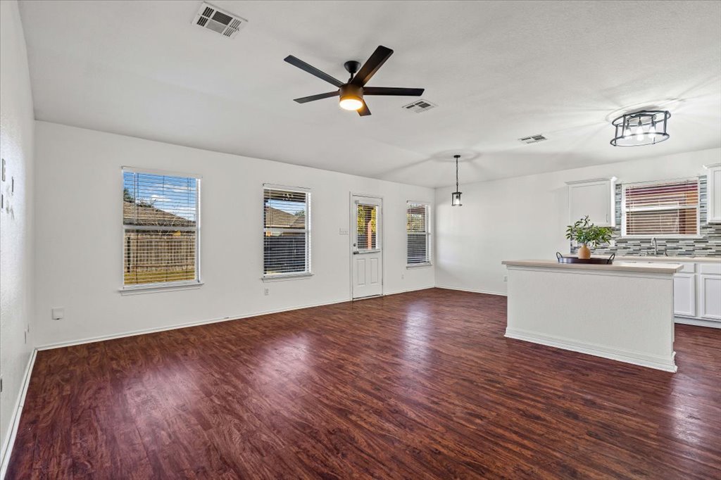 17912 Aleppo Pine Elgin, TX 78621 - Photo 2 of 30 Unfurnished living room featuring dark wood-style floors and a ceiling fan