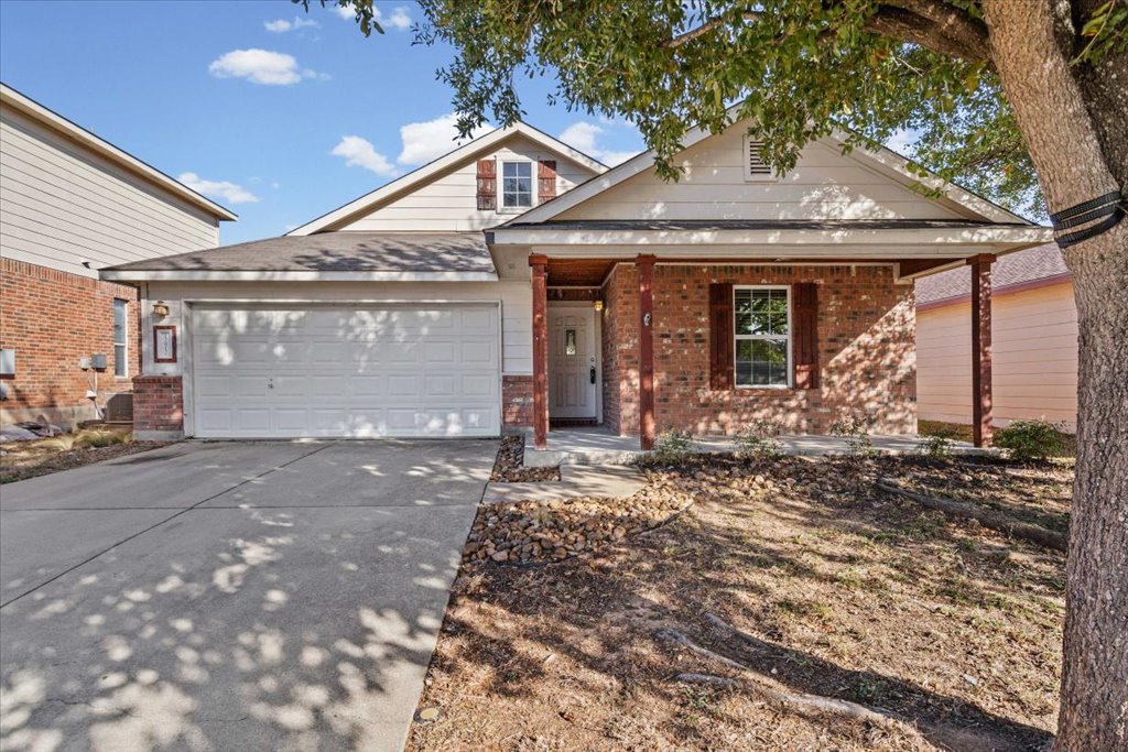 17912 Aleppo Pine Elgin, TX 78621 - Photo 5 of 30 View of front of property with covered porch, brick siding, concrete driveway, and a garage