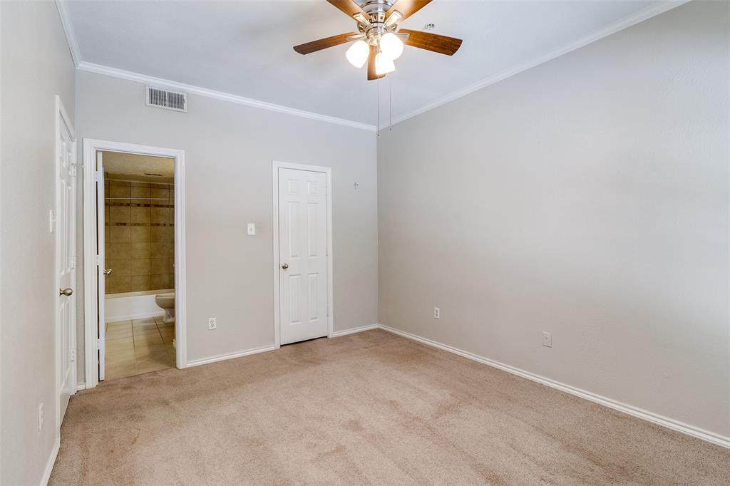 6003 Oram Street, Unit 104 Dallas, TX 75206 - Photo 13 of 23 an empty room with closet and a chandelier fan