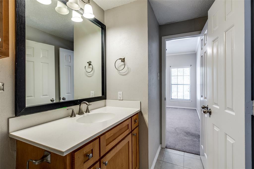 6003 Oram Street, Unit 104 Dallas, TX 75206 - Photo 15 of 23 a bathroom with a sink vanity and a mirror