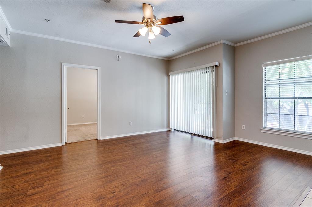 6003 Oram Street, Unit 104 Dallas, TX 75206 - Photo 2 of 23 an empty room with wooden floor and windows