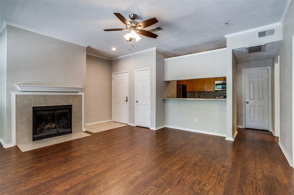 6003 Oram Street, Unit 104 Dallas, TX 75206 - Photo 5 of 23 a view of an empty room with wooden floor and a fireplace