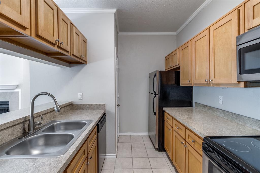 6003 Oram Street, Unit 104 Dallas, TX 75206 - Photo 8 of 23 a kitchen with stainless steel appliances granite countertop a sink stove and refrigerator