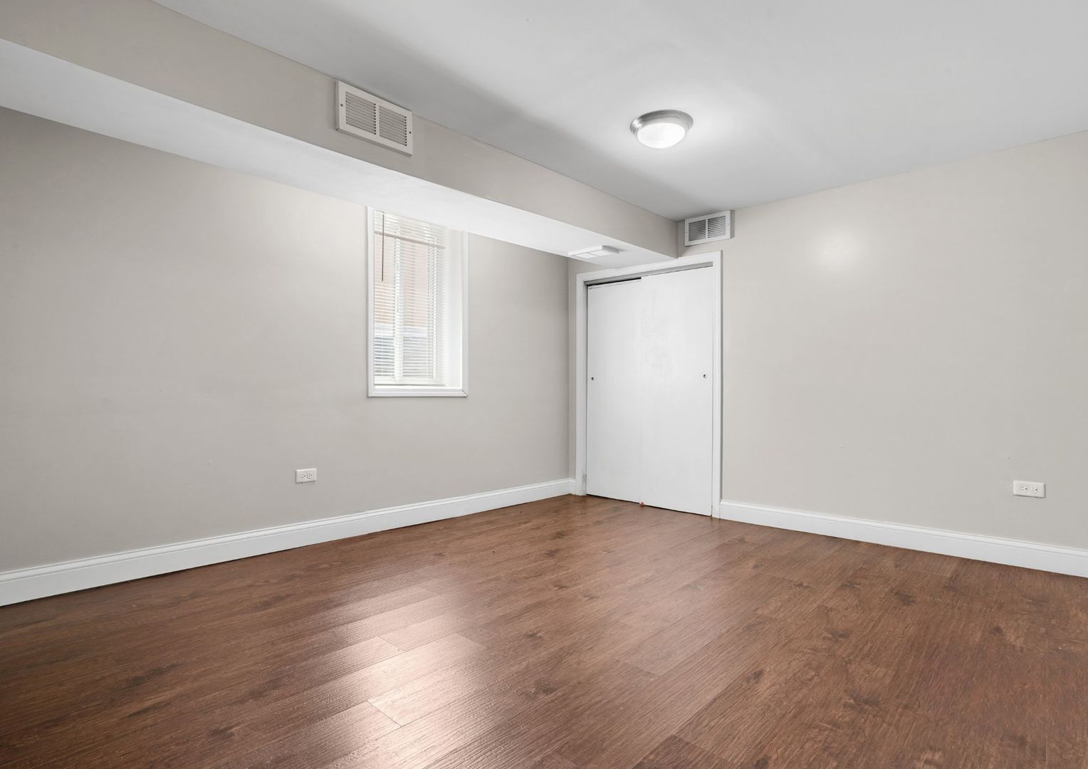 294 Madison Avenue Calumet City, IL 60409 - Photo 16 of 19 a view of an empty room with wooden floor and a window