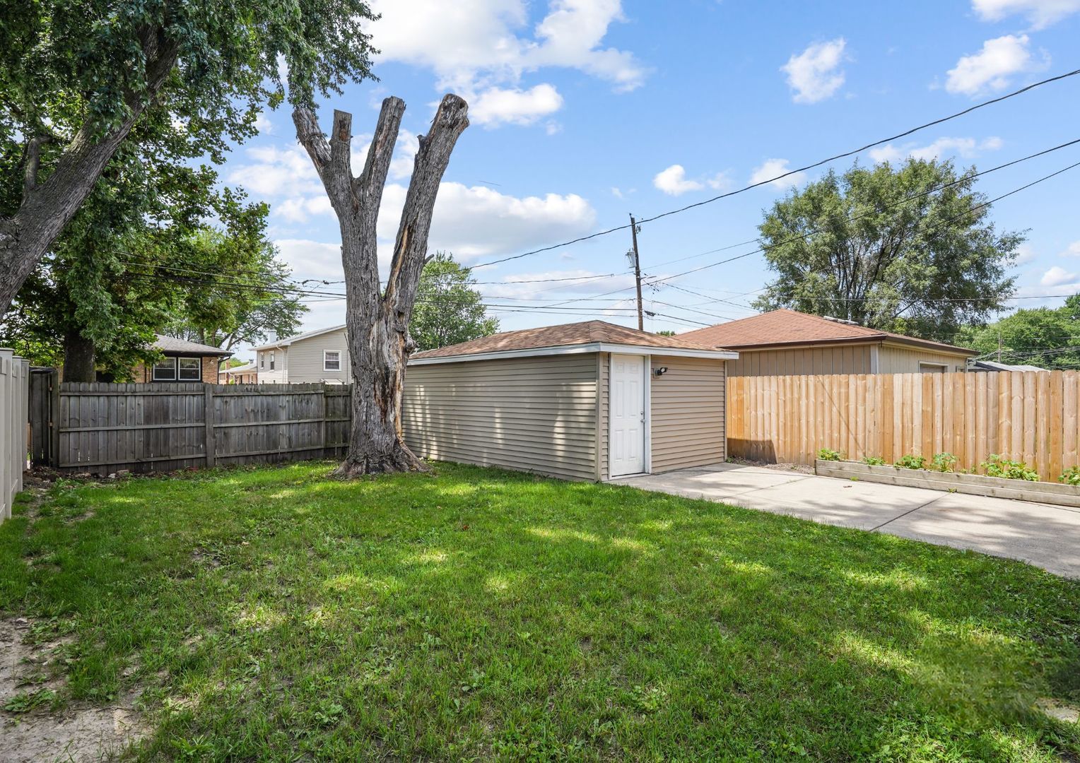 294 Madison Avenue Calumet City, IL 60409 - Photo 17 of 19 a front view of a house with a yard and trees